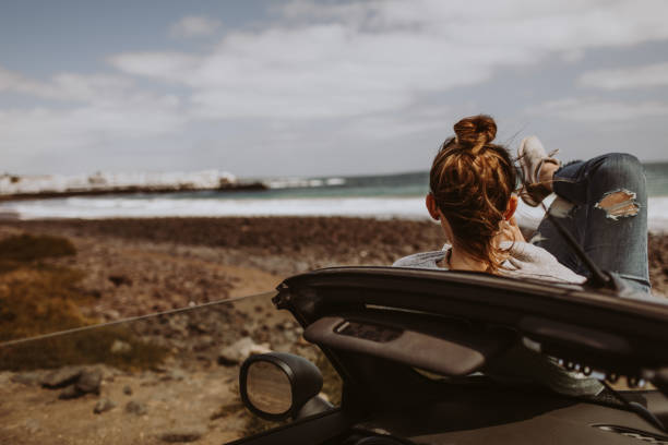 istock Young woman enjoys seaside view 946269784