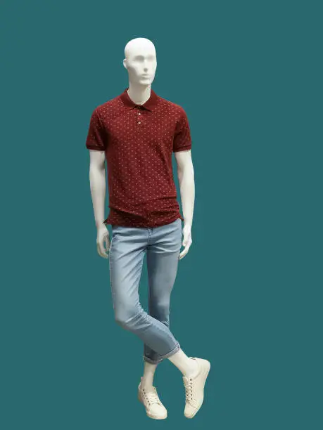 Full-length male mannequin dressed in t-shirt and jeans, isolated. No brand names or copyright objects.
