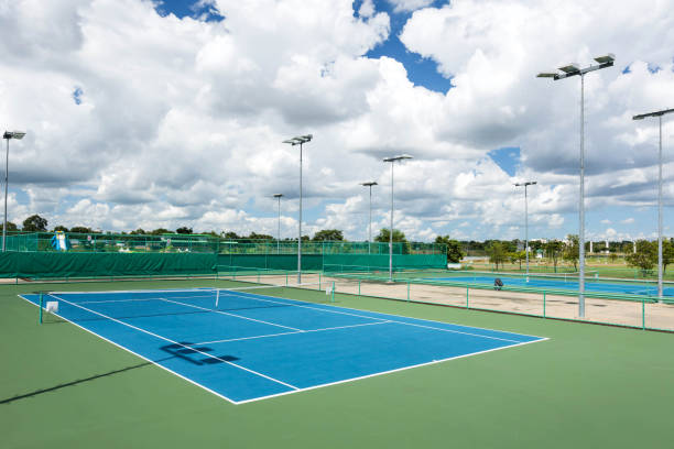 istock Empty Tennis Court Against Cloudy Sky 946274098