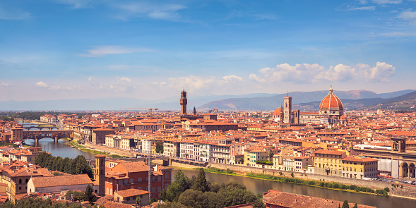 View of central Florence, Italy. On the left is the Ponte Vecchio bridge over Arno river, center is the tower of Palazzo Vecchio (town hall), and on the right Florence Cathedral.