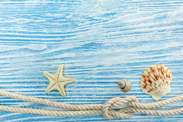 istock blue painted wooden boards background with seashell, starfish and rope 946290638