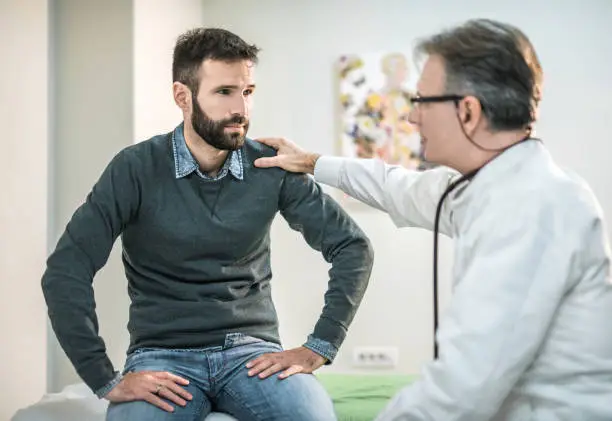 Photo of Worried mid-adult visiting a doctor.