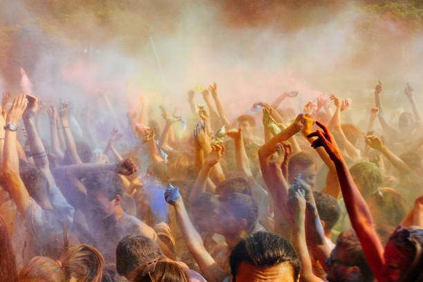 istock happy people crowd partying under colorful powder cloud 946299236