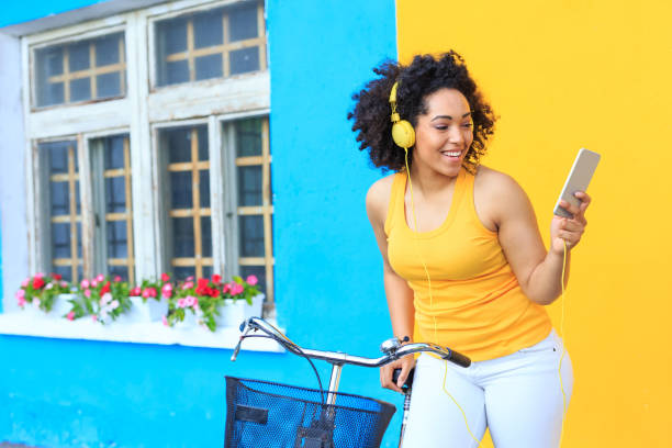 istock Woman with bike using smart phone 946300096
