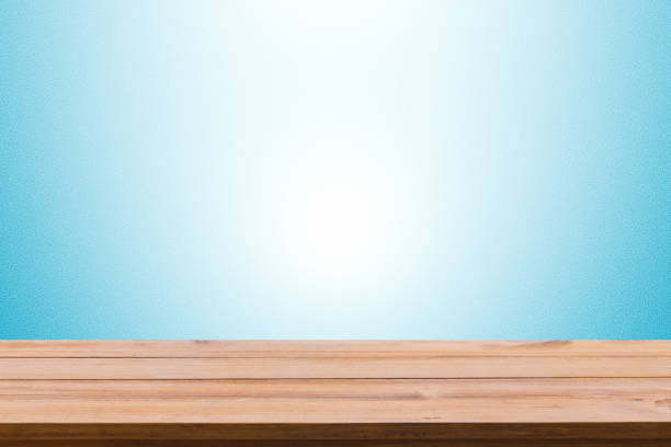 istock Close-Up Of Empty Wooden Table Against Blue Background 946309182