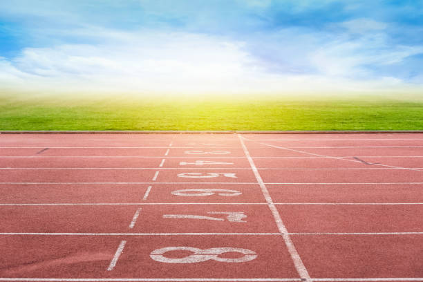 istock Running Track By Field Against Cloudy Sky 946311886