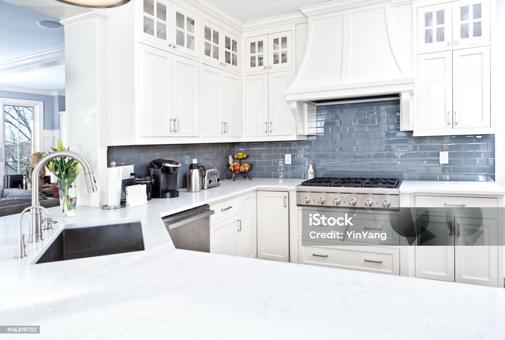 Modern Kitchen Design with Stainless Appliance A contemporary home kitchen with stainless steel appliances and painted white cabinets. Kitchen Stock Photo