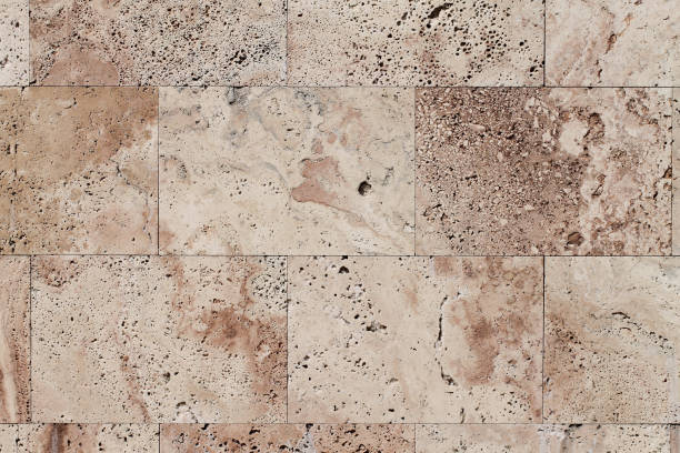 istock Natural Italian stone. Smooth travertine surface. A sample of wall cladding with natural stone. Background. 946327584