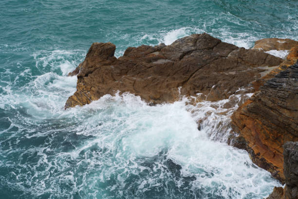 istock stormy sea crashes against the rocks 946328266