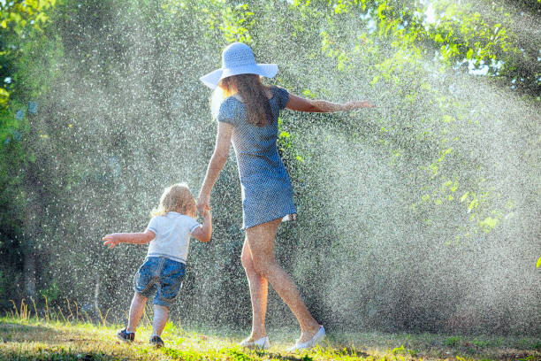 istock Mother and child having fun in the rain 946331348