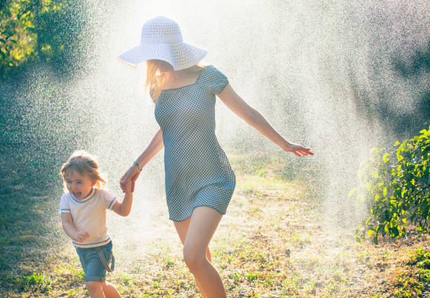 istock Mother and child having fun in the rain 946331354