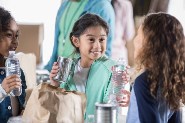istock Young friends work together during food drive 946334480