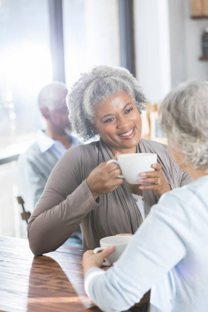 istock Caring senior woman has coffee with friend 946334524