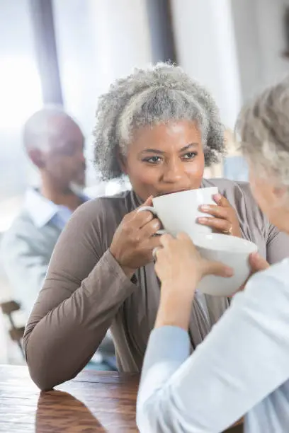 Photo of Beautiful African American woman has coffee with friend