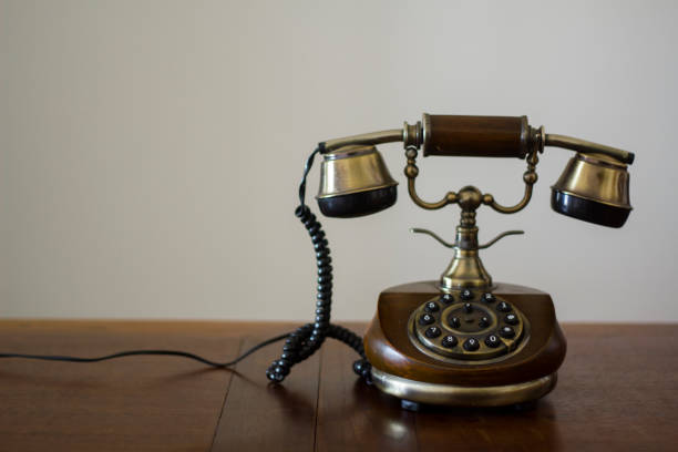 istock Vintage phone on wooden table 946344956