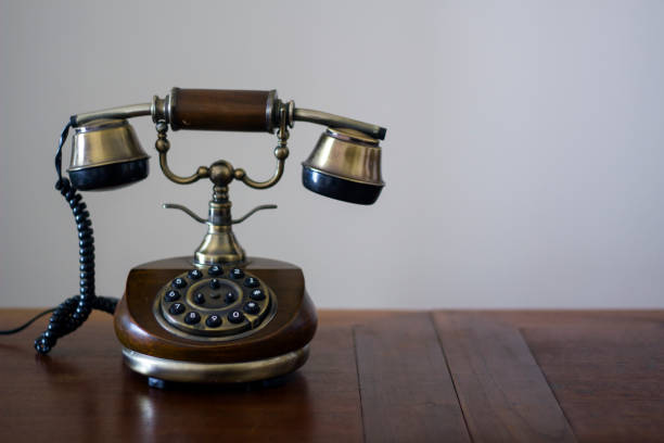 istock Vintage phone on wooden table 946344960