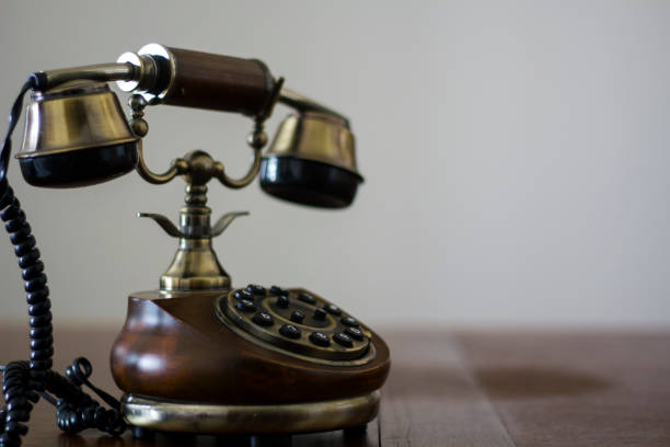 istock Vintage phone on wooden table 946345070