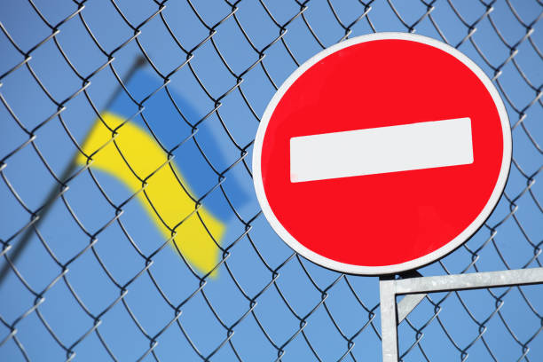 istock Ukrainian flag behind a fence 946355686