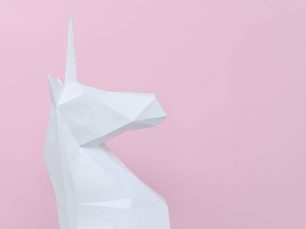istock White paper unicorn on a pink background. Space for text 946363782