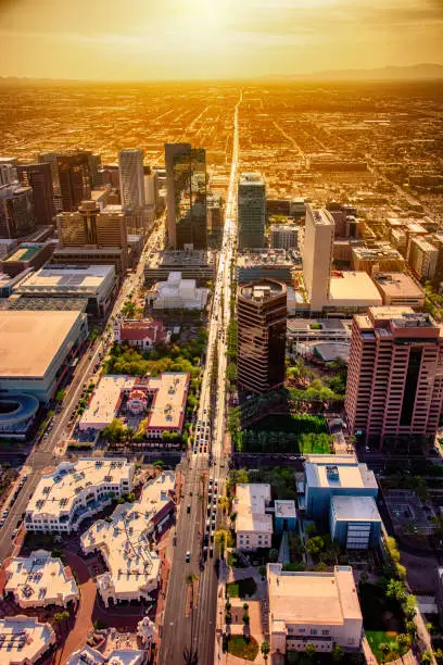 An aerial view of downtown Phoenix, Arizona at dusk shot from a helicopter at an altitude of about 2000 feet.