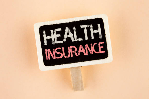 istock Handwriting text Health Insurance. Concept meaning Health insurance information coverage healthcare provider written on Wooden Notice Board on the plain background 946373652