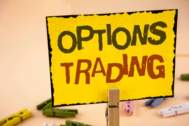 istock Handwriting text writing Options Trading. Concept meaning Options trading investment commodities stock market analysis written on Yellow Sticky Note Paper on the plain background Wooden Clips. 946375912