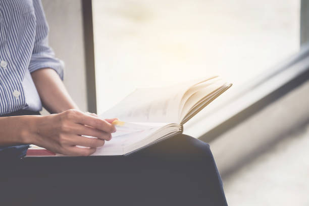 istock Midsection Of Woman Holding Book 946392304