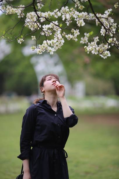 istock Young woman enjoying spring blossoms 946395626