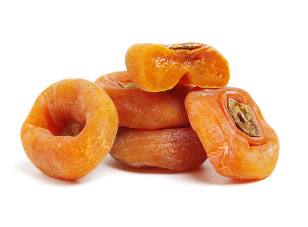 istock Dried flattened persimmon fruits on white background 946398410