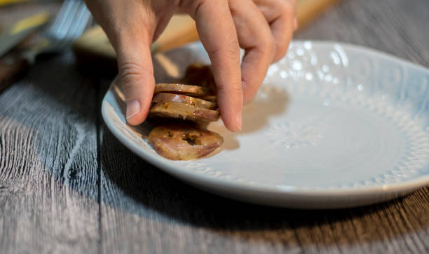 istock cutting cooked sausage to slices 946403436