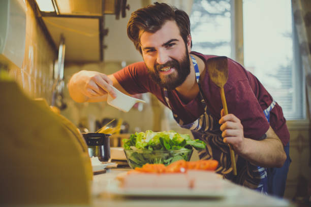 istock Young man preparing healthy meal in the kitchen 946409576