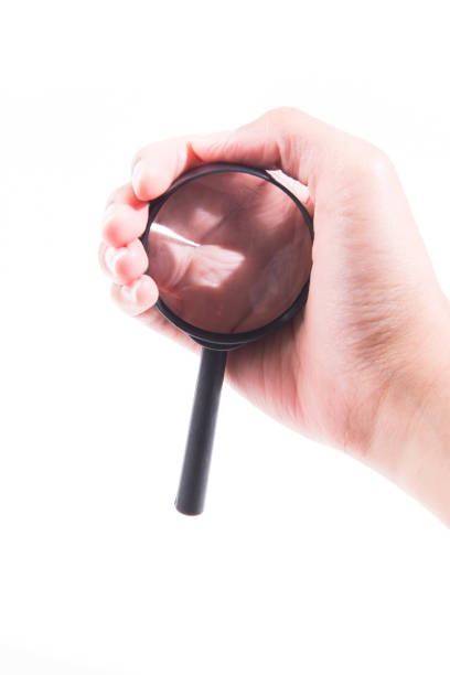 istock Female hand with magnifying glass. 946424032