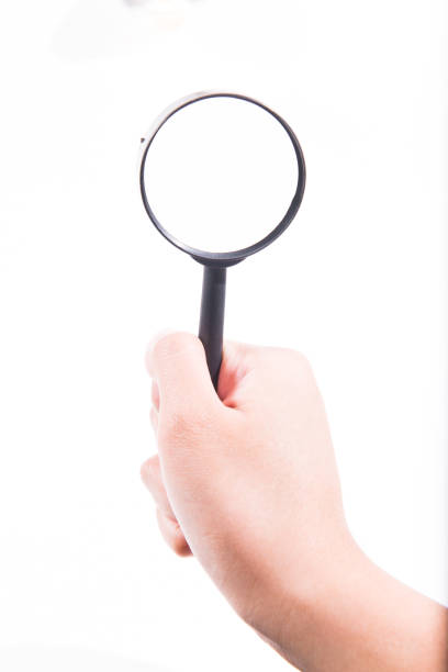 istock Female hand with magnifying glass. 946424060