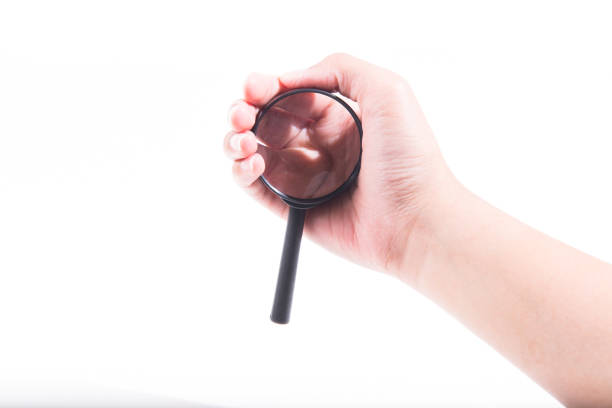 istock Female hand with magnifying glass. 946424140