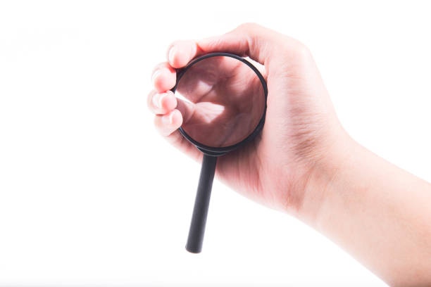 istock Female hand with magnifying glass. 946424188