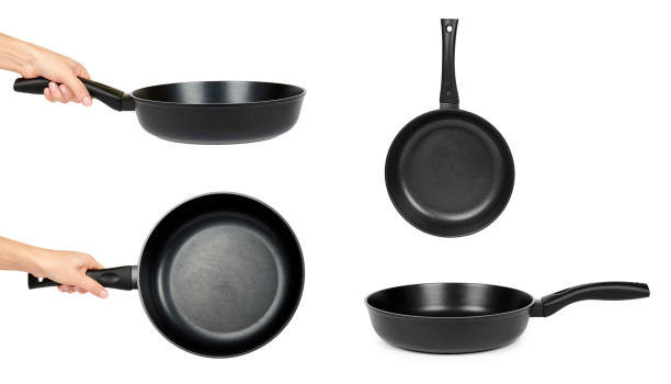 istock Set of different black fry pans in hand isolated on white background 946437694
