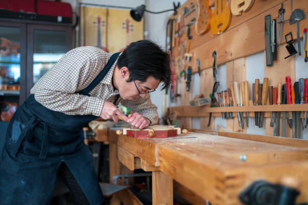 istock Craftsman carving a violin 946441642