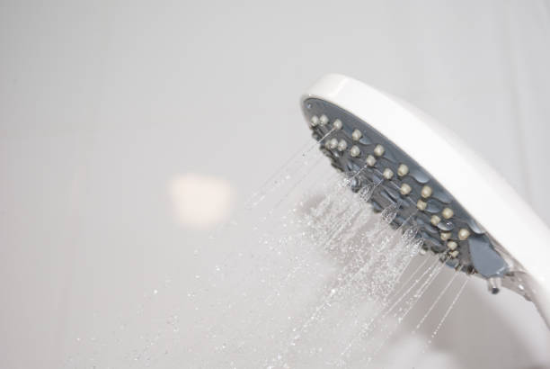istock Close up water flowing out from shower in bathroom 946442018