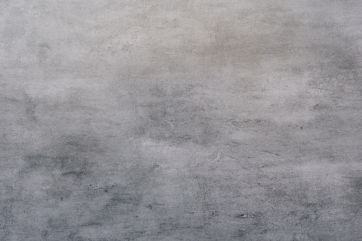 Background of a gray stucco coated and painted exterior, rough cast of cement and concrete wall texture