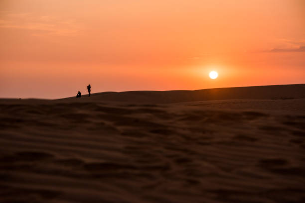 istock Sun setting below horizon in Mu Ne sand dune in Vietnam 946459048