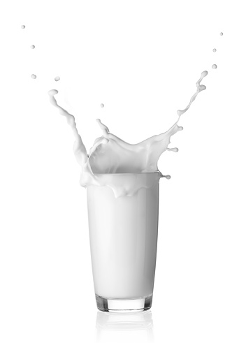 Splash in a glass of milk isolated on a white background