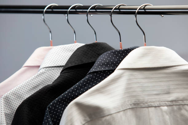 Shirts hanging on rack in shopping mall