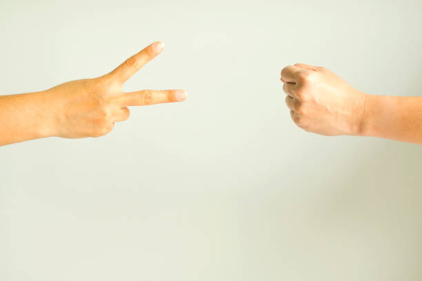 istock Two person playing rock paper scissors. 946469602
