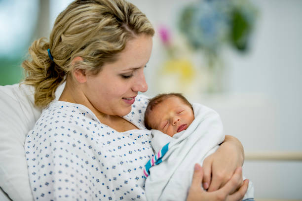 istock Cradling Baby In Her Arms 946472402