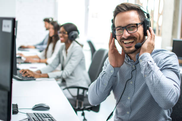 istock Portrait of cheerful customer support telephone operator in call centre 946486480