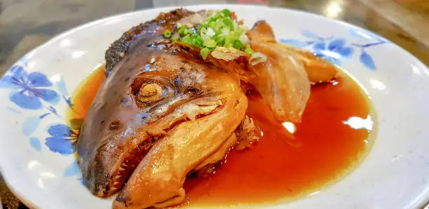 Photo of Delicious Salmon head boiled with Soy sauce in Japanese style dish