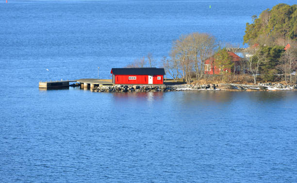 istock Stockholm archipelago island, largest archipelago in Sweden, and second-largest archipelago in Baltic Sea. Red wooden house 946491092