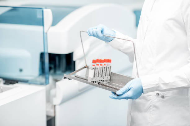 istock Holding test tubes in the labolatory 946491094