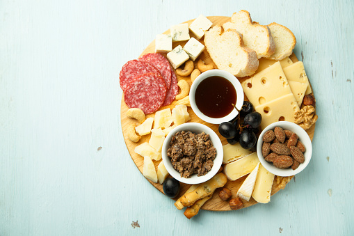 Cheese board with fruits, nuts and meat