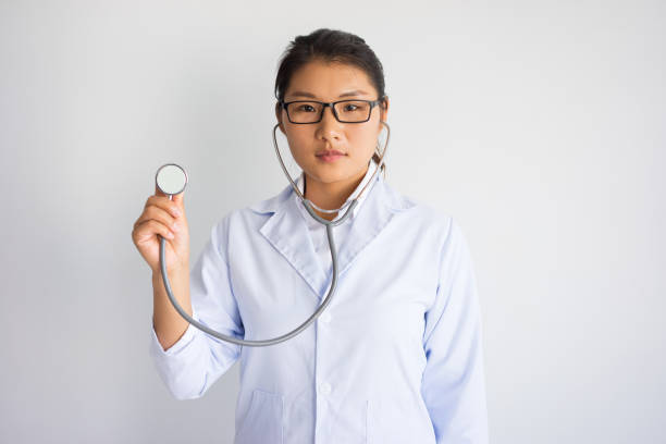 istock Serous young Asian female doctor using stethoscope 946502744